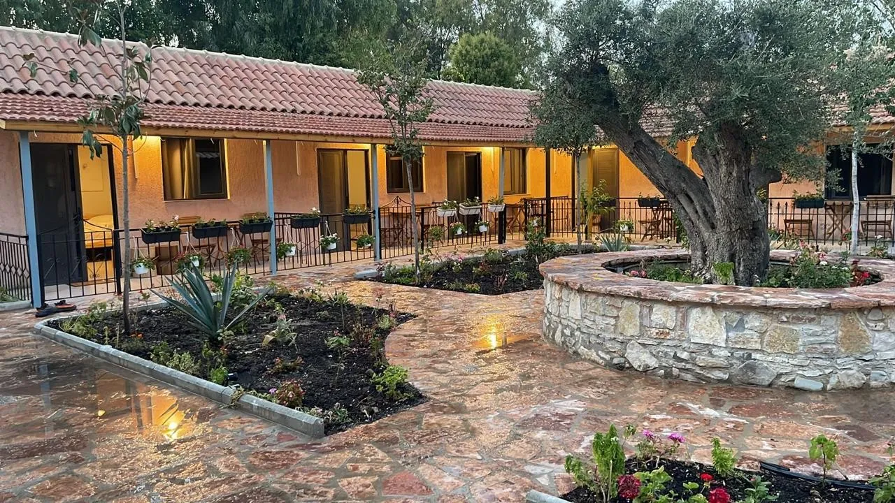 The guest wing and the old olive tree in the courtyard at dusk