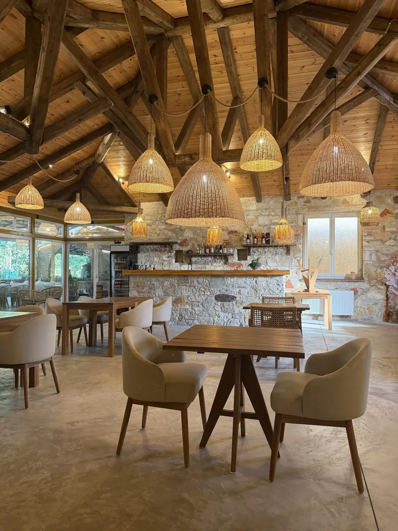 Armchairs and tables in the hall under the pendant lamps